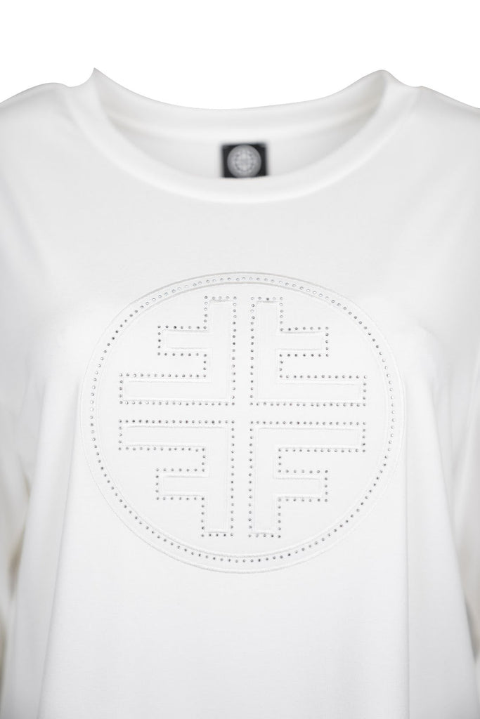 Detailansicht Logo - Weißes Damen-Langarmshirt mit Rundhalsausschnitt und kreisförmigem Faber-Logo in Strasssteinen mittig auf der Brust.